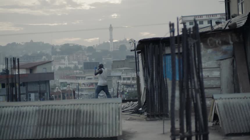 Man boxing on top of building