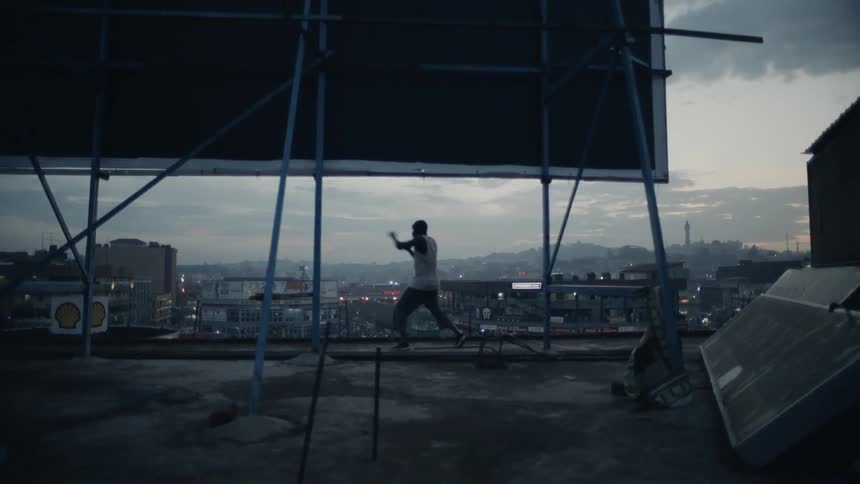 Man on rooftop practices boxing