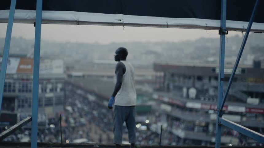 A man stands on a building rooftop