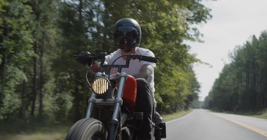 Man motorcycles on a rural road