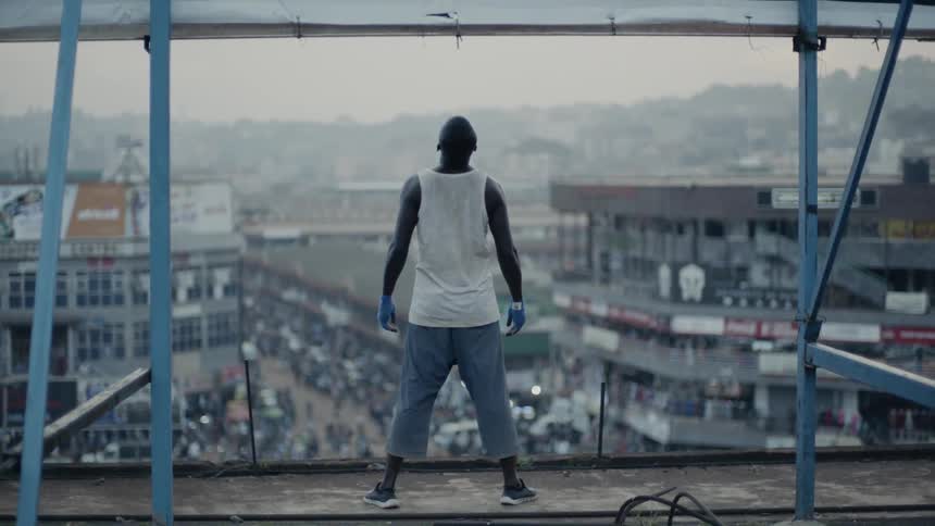 A man stands on a building rooftop