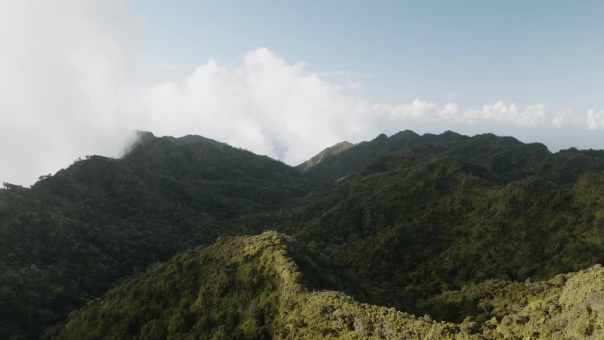 Clouds float over mountain ridges