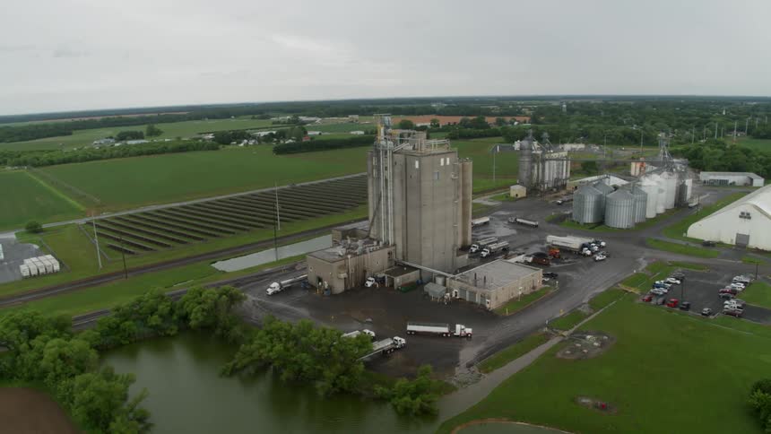 Farm fields and buildings with pools of water nearby