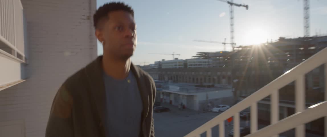 Man walks up a flight of stairs on a sunny day
