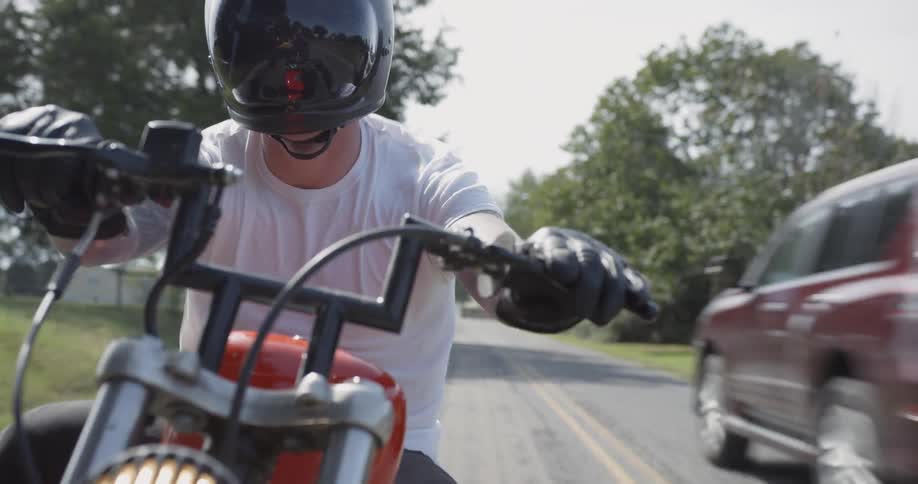 Man motorcycles on a rural road