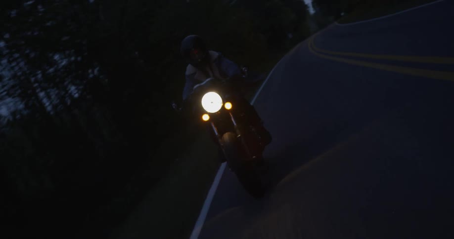 Person is riding motorcycle on highway at night