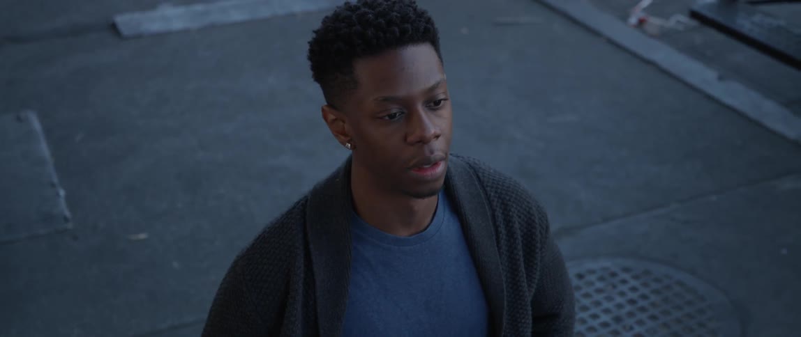 A man looks sad while standing on concrete