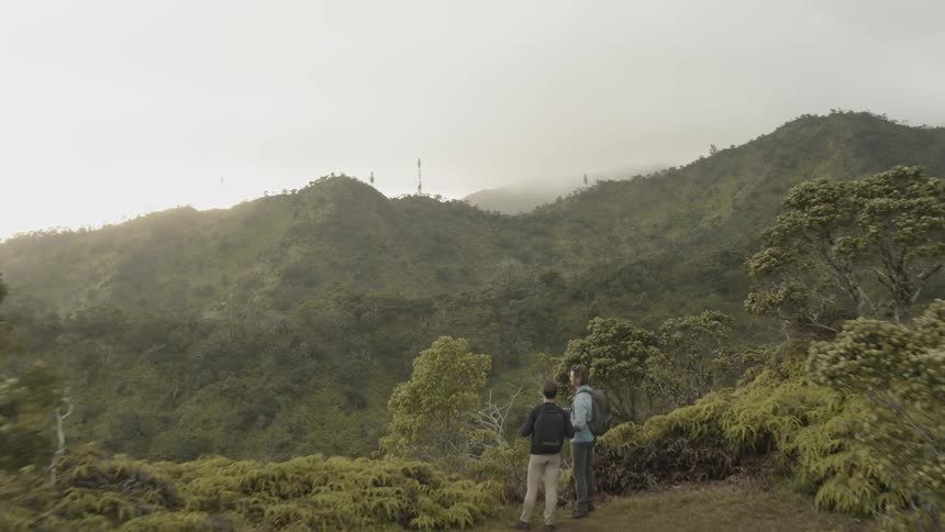 Two men hike in mountains