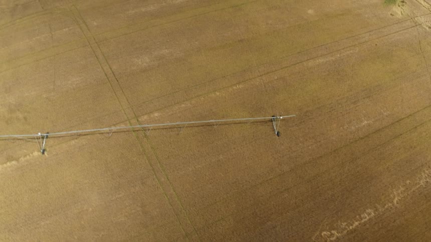 Large sprinkler waters vast area of farm crops