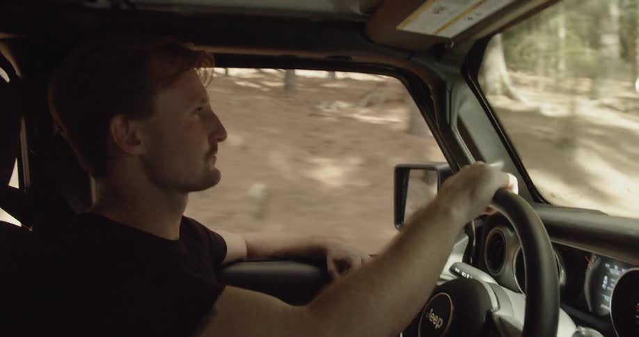 Man drives a vehicle down a country road