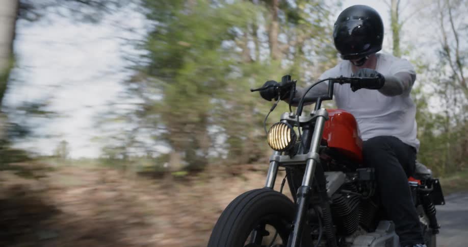 Man motorcycles on a rural road