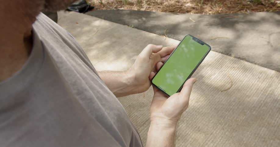 A man scrolls on a smartphone