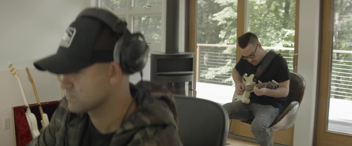 Two men collaborate in a music room