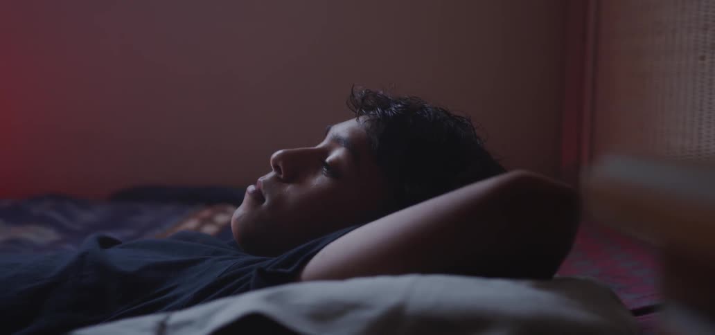 Boy laying awake in bed during the day