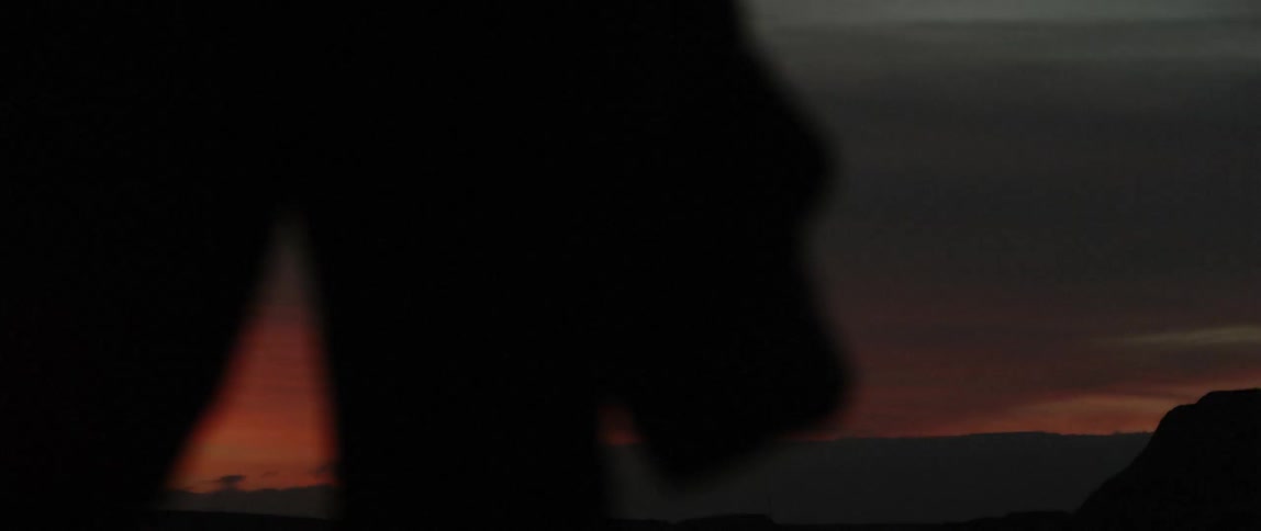 Person hiking at sunset