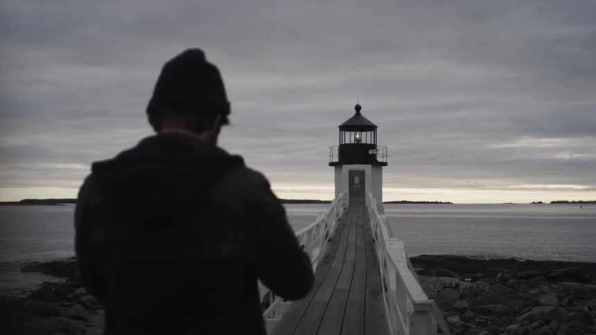 Guy Exploring By Lighthouse