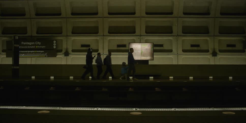 People walk on the platform in a train station