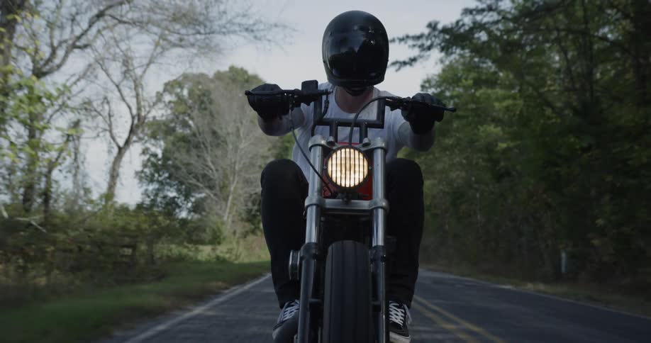 Man rides motorcycle down highway