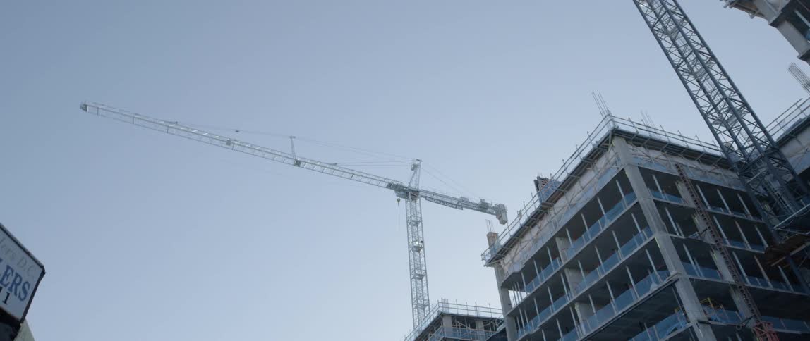 Cranes construct a city building