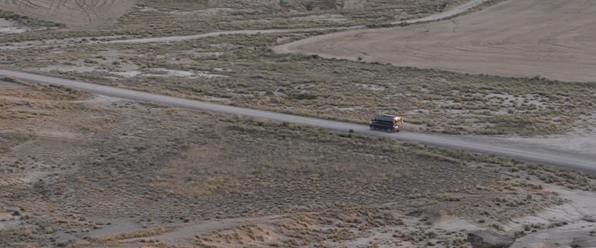 A van drives in a desert
