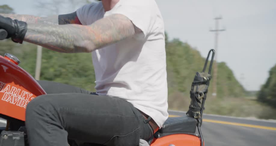 Man is riding motorcycle on sunny day