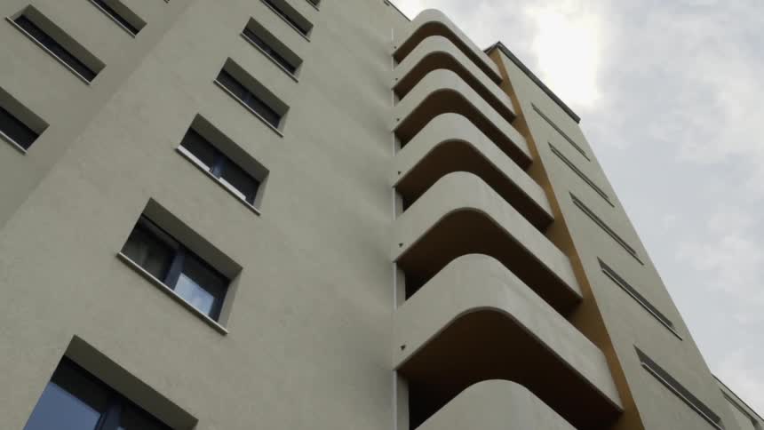Large building with many floors on a cloudy day