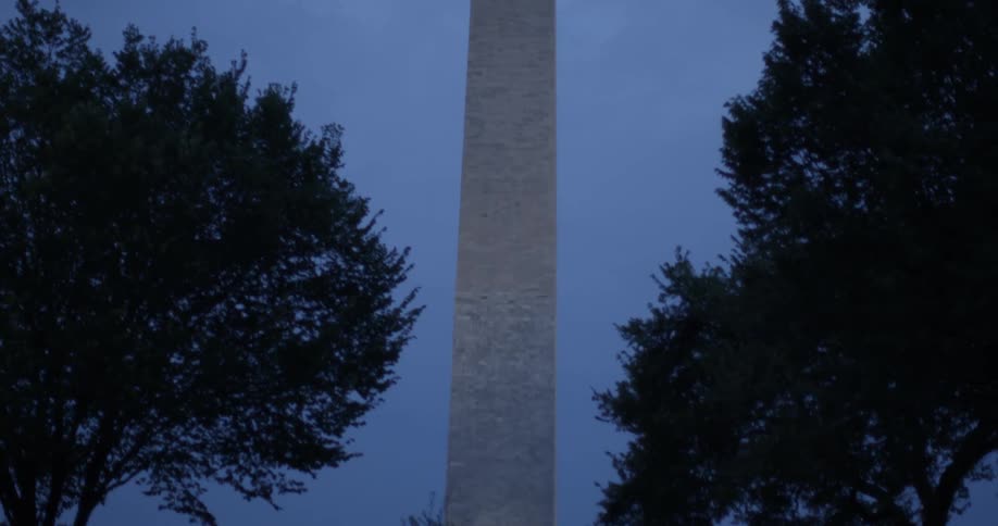 Lights illuminate the base of the washington monument at night
