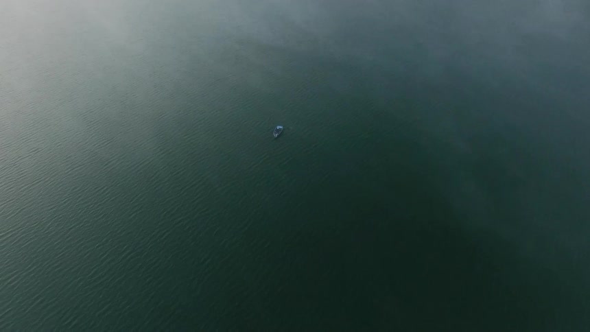 A boat floats on the calm water
