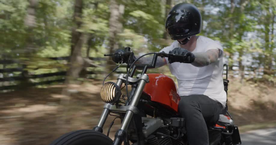 Man is riding motorcycle on country road
