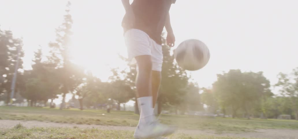 Boy practices dribbling soccer ball