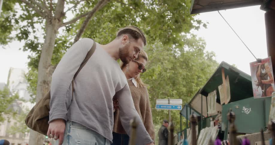 A man and woman stop at a street vendor