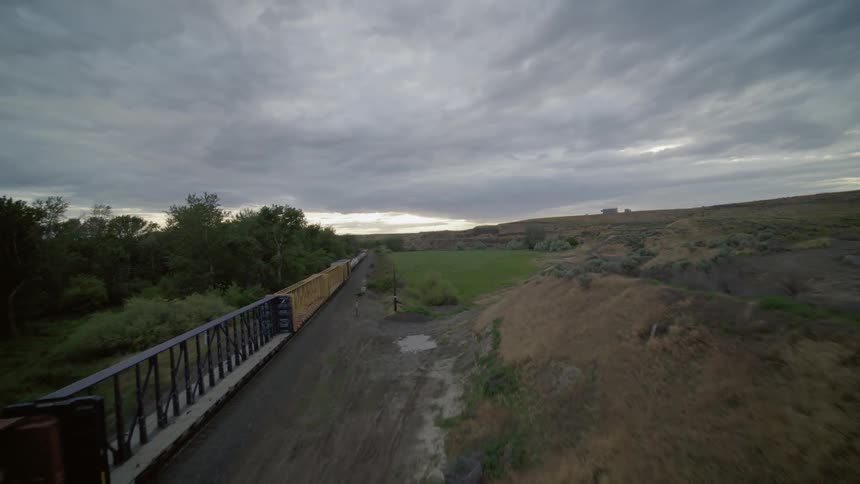 Following alongside a fast moving freight train