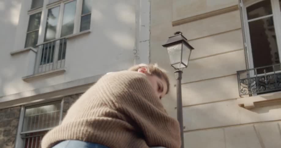 A woman jumps into a man's arms and kisses him