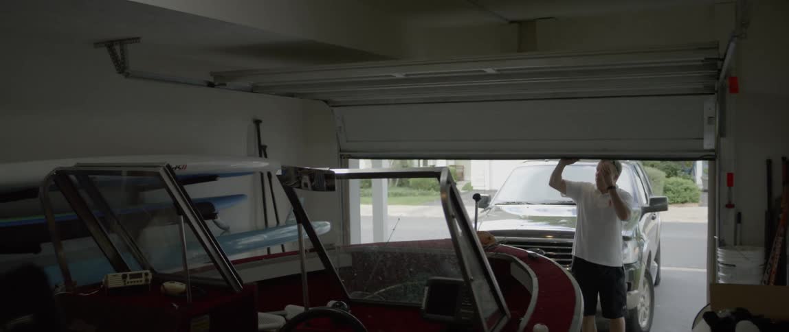 Man opens a garage door and walks inside