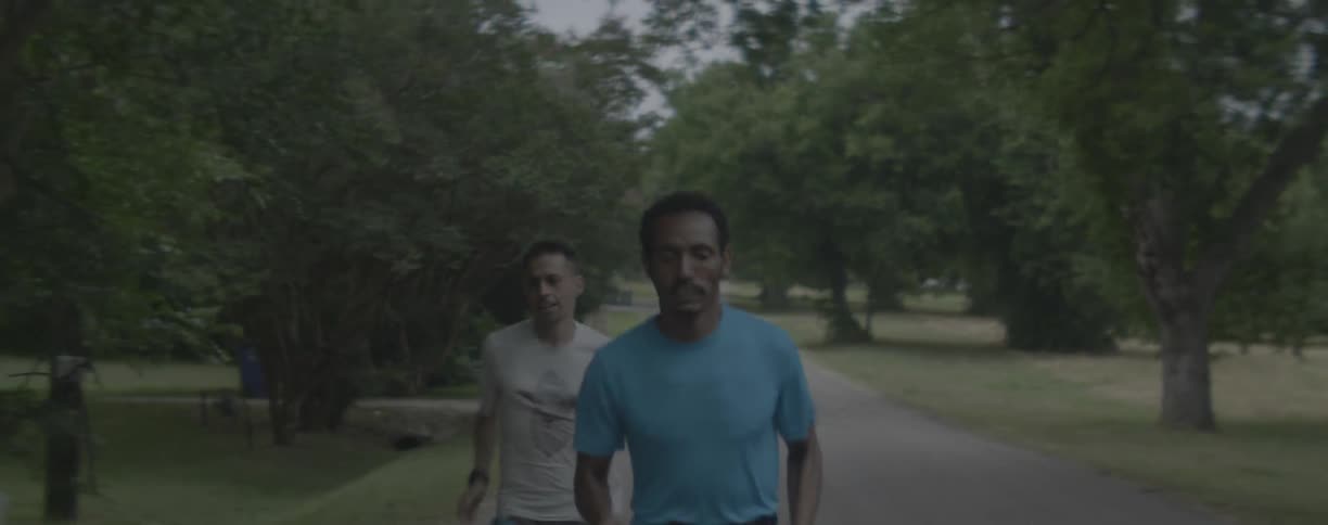 Two men are jogging on neighborhood road
