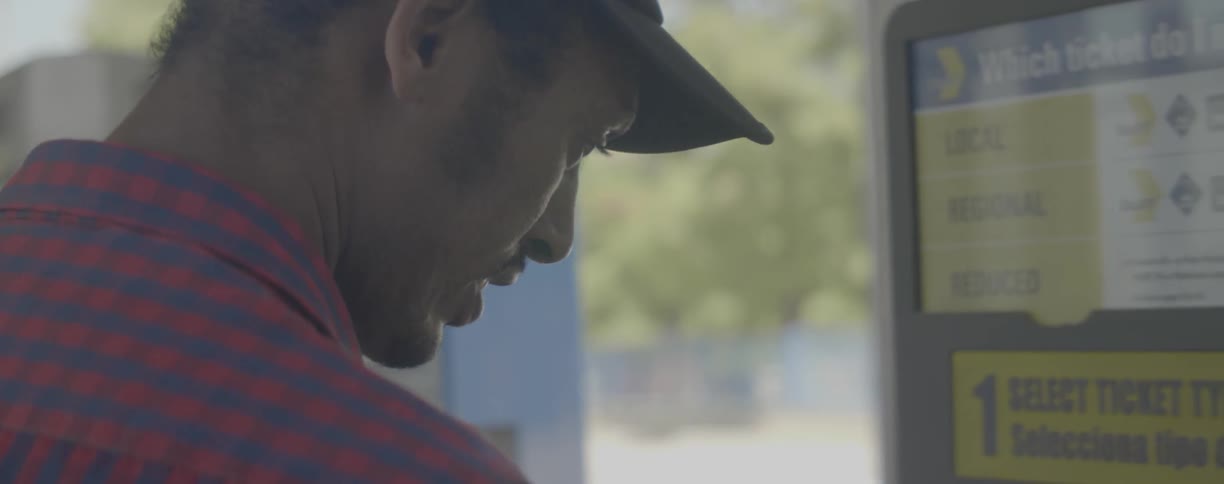 A man buys a ticket from a machine