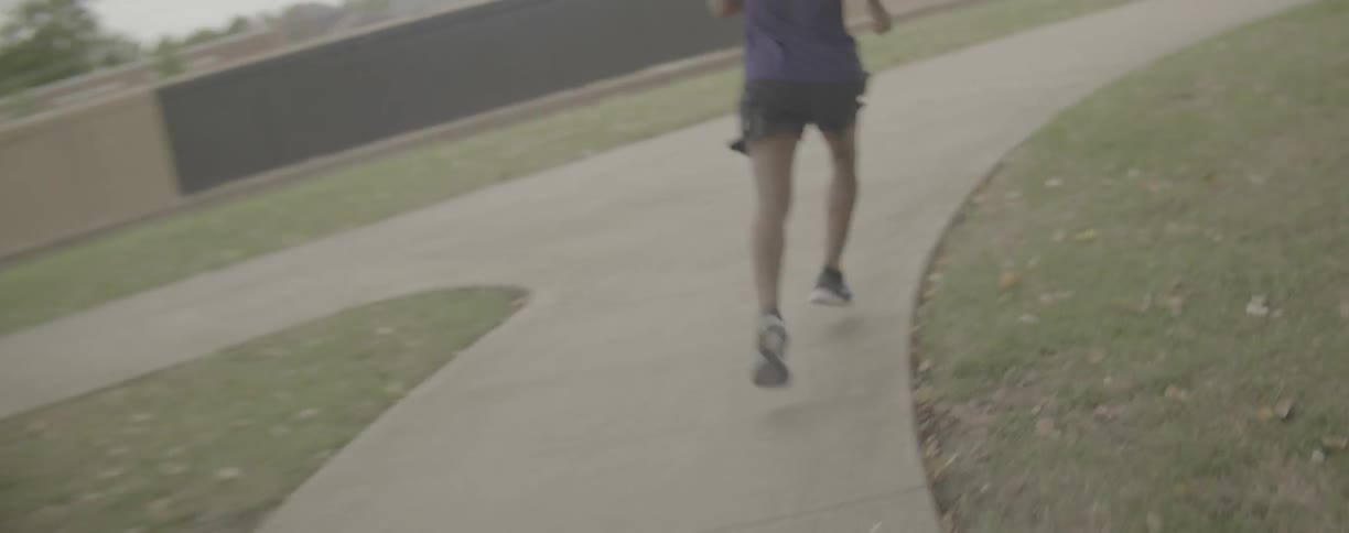 Man is jogging on path in park