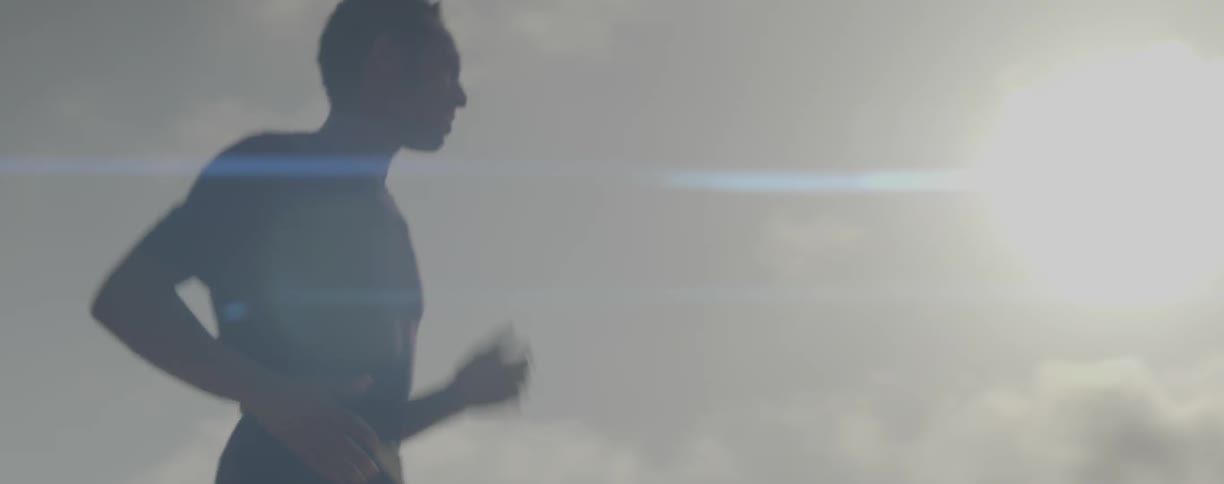 Man jogs under the sunny sky