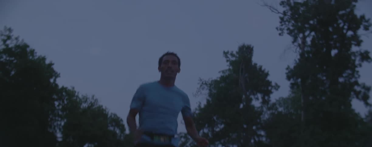 A man jogs outside at dusk