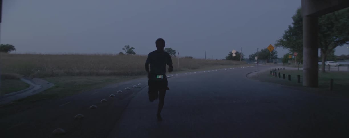 Man runs along a highway
