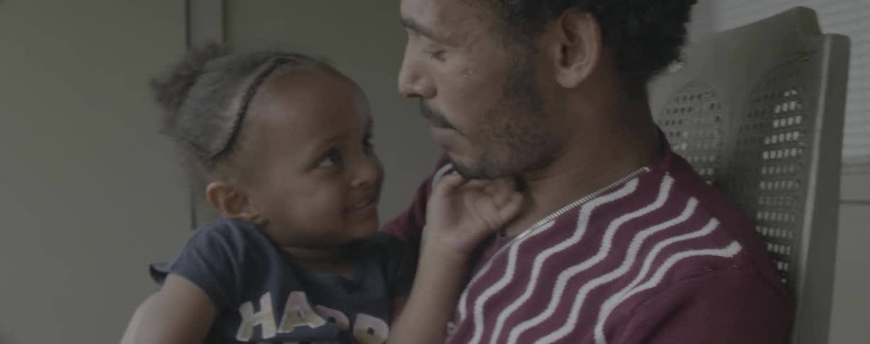 Man is tickling and playing with his young daughter