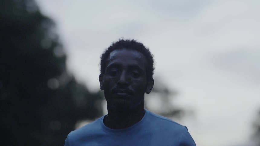 Man jogs outside at sunset