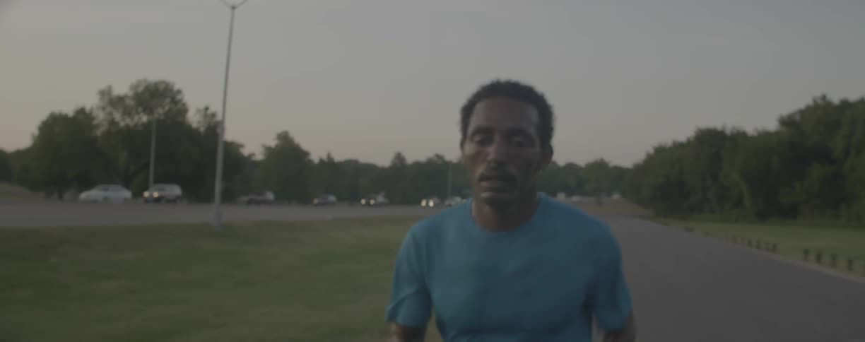 A man jogs by a busy road