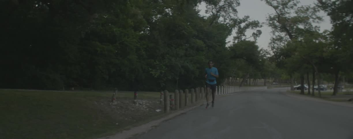 Man runs down a road near the posts