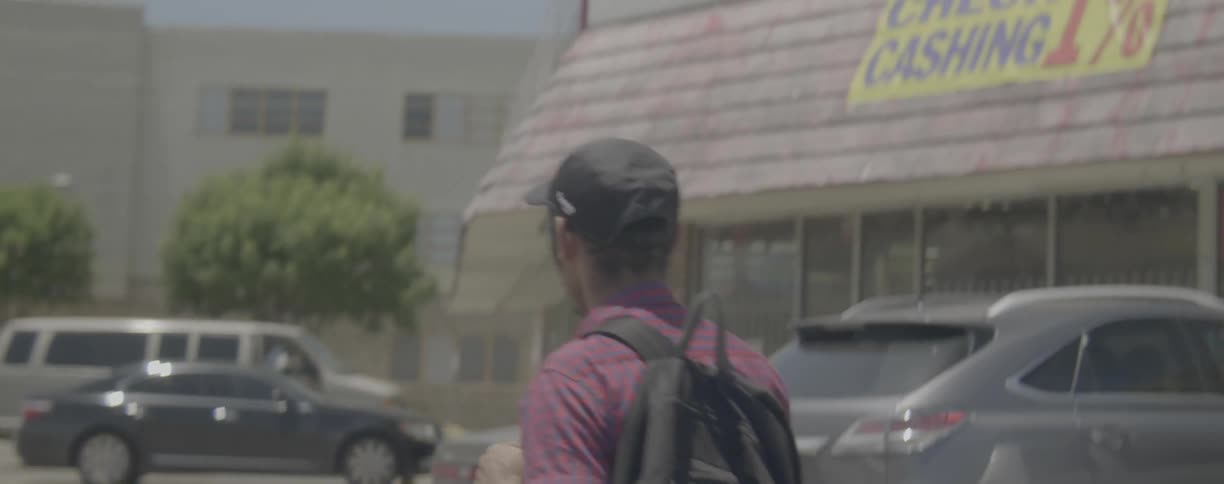 A pedestrian walks on a city sidewalk