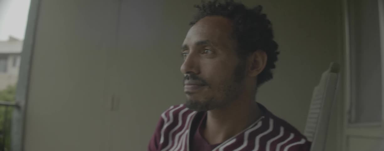 Man blinks as he stares ahead