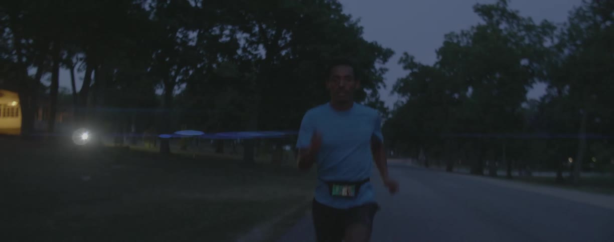 Man jogs on a rural road at night