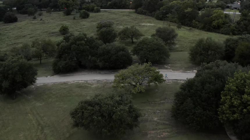 A runner jogs on a rural road