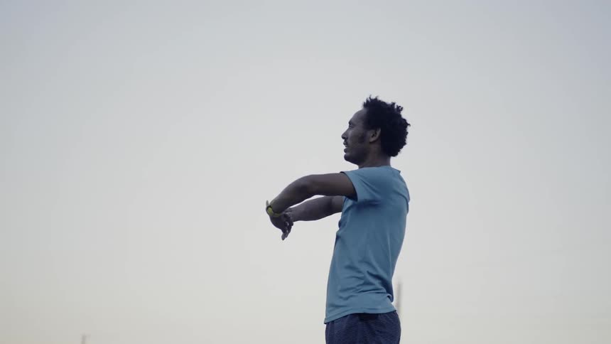 Man stands stretching