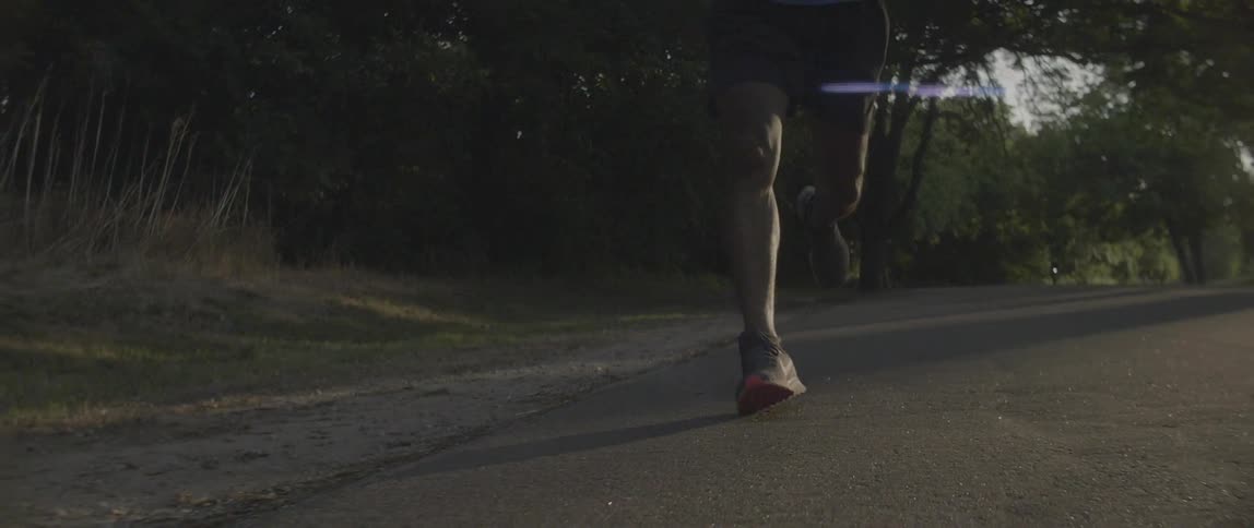 Man is jogging on street in the morning